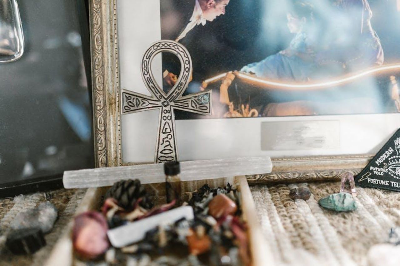 Capricorno_comprensione_necessaria_q07AY5BtRT - Confidenze24 Source: RDNE Stock project - pexels - A mystical arrangement featuring an Ankh symbol with various crystals, depicting a spiritual ambiance.