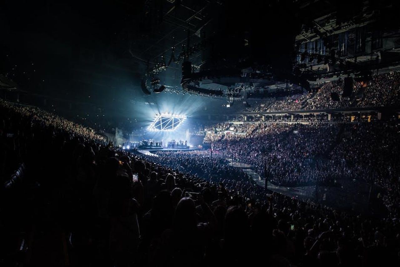 I_fan_non_vedono_lora_del_ritorno_di_Nancy_yEkdtW3Mp7 - Confidenze24 Source: Wendy Wei - pexels - Energetic concert scene featuring a packed audience, vibrant lights, and a live performance on stage.