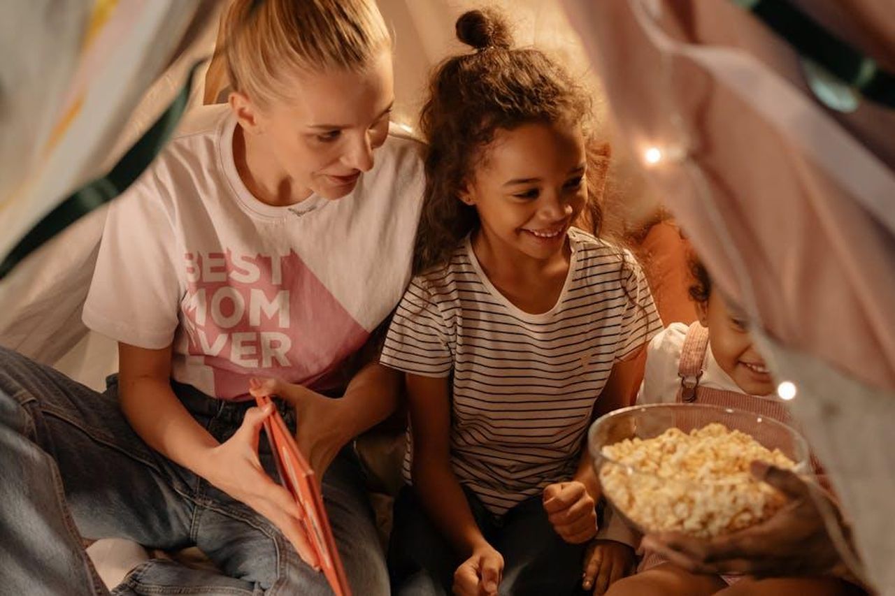 Il_nuovo_nome_As_Ever_mAeXWG9KpX - Confidenze24 Source: cottonbro studio - pexels - Mother and daughters enjoying popcorn in a cozy indoor tent setting, sharing joyful moments.