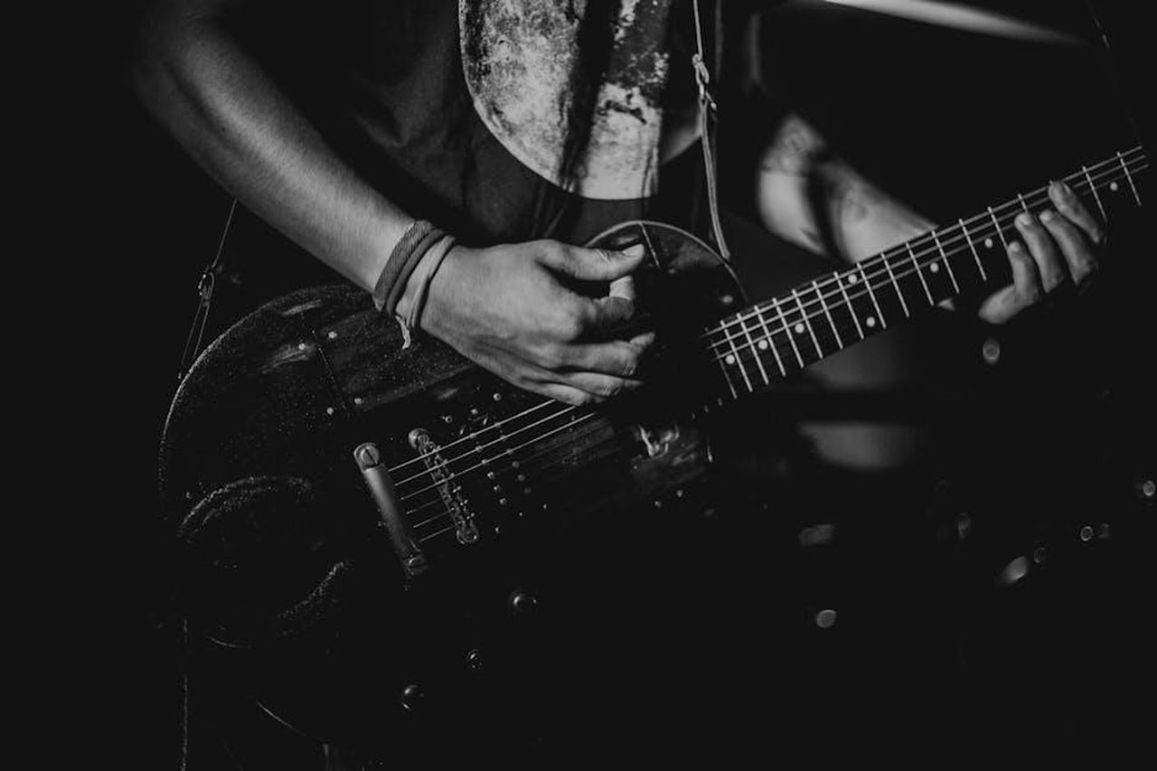 Il_percorso_di_Helena_e_Javier_6LVJNXv9AO - Confidenze24 Source: Edward Eyer - pexels - Black and white photo of a guitarist playing during a live performance.