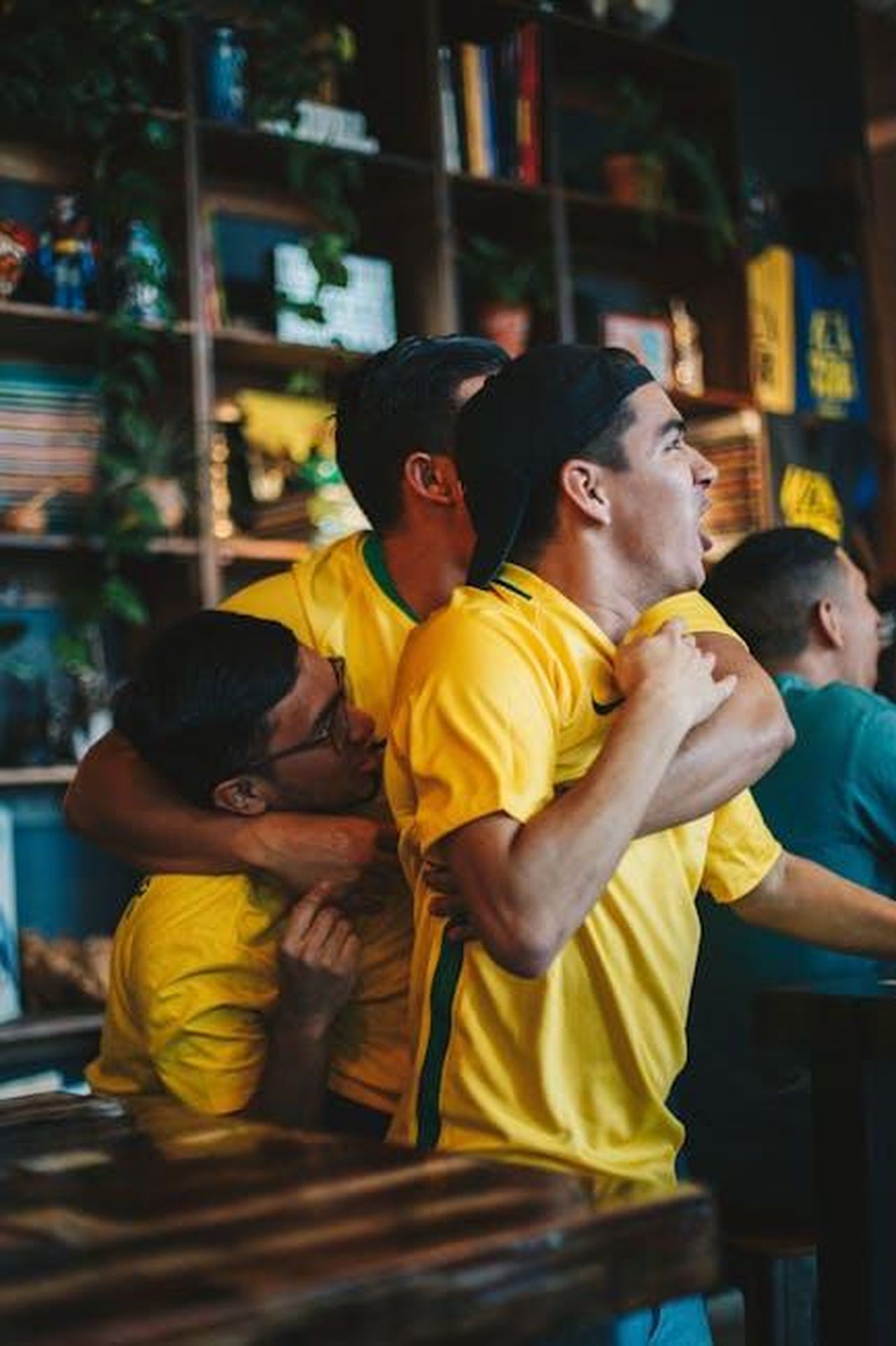 Il_supporto_del_pubblico_e_limportanza_della_vittoria_7kFVy9T7eJ - Confidenze24 Source: ELEVATE - pexels - A group of joyful soccer fans in yellow jerseys celebrating a goal in a pub.