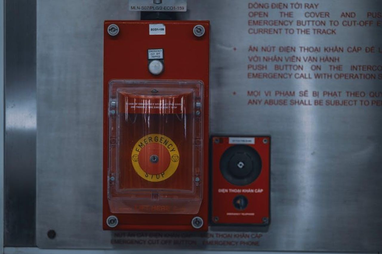 La_reazione_di_Julianne_Moore_27dtBPoBPg - Confidenze24 Source: Toàn Văn - pexels - Close-up of an emergency stop button with warning text on an industrial panel.
