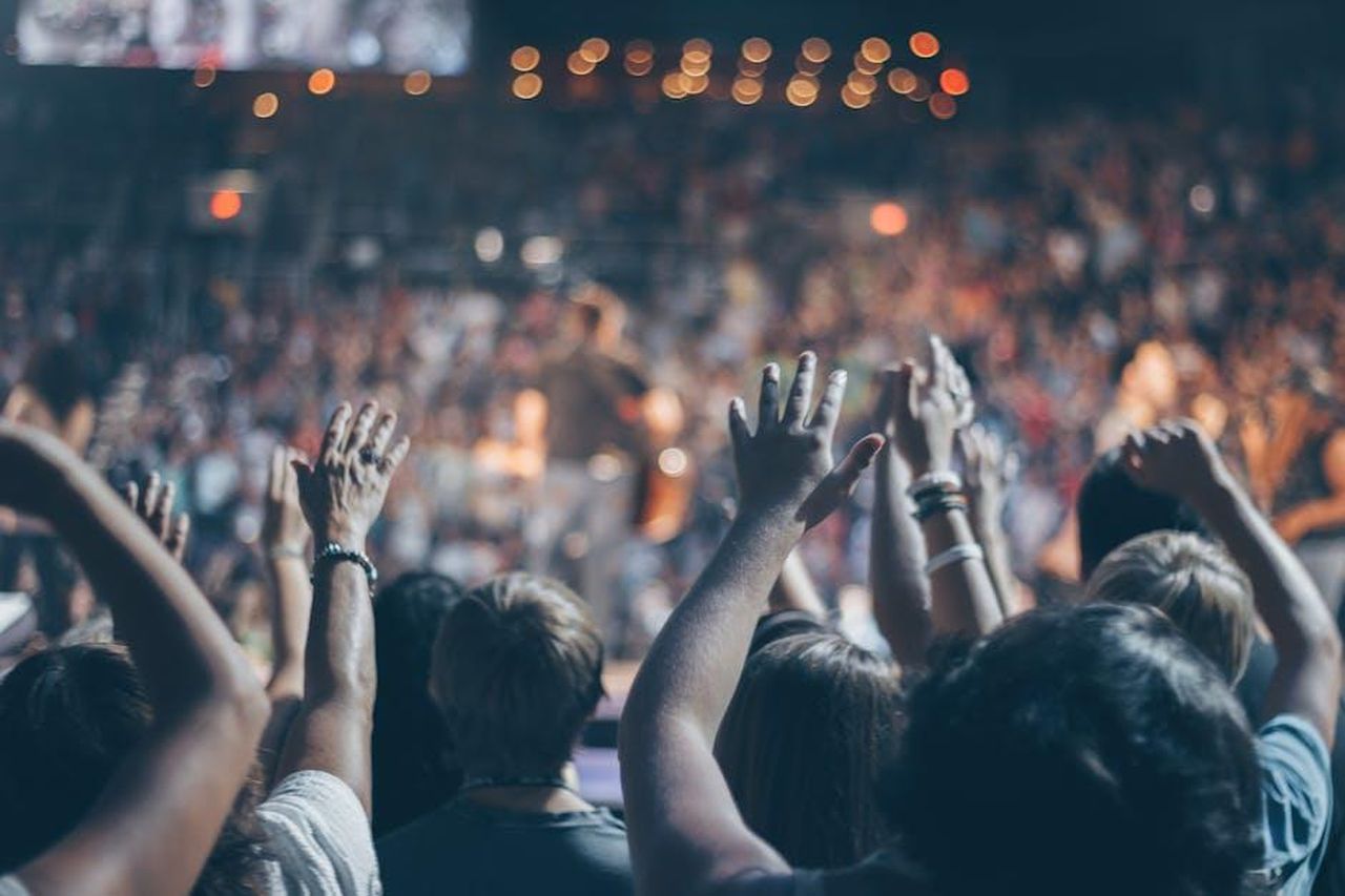 La_soap_opera_ha_retto_bene_anche_contro_il_Festival_di_Sanremo_2025_DGiCAJvSKd - Confidenze24 Source: Josh Sorenson - pexels - Energetic crowd at a live concert with hands raised and bright lights.