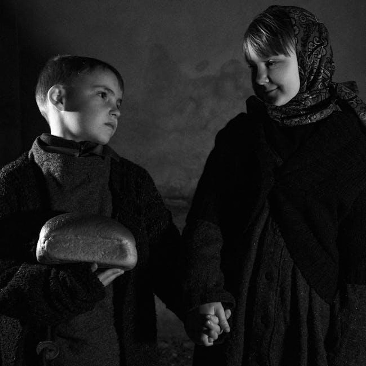 La_storia_del_marchio_As_Ever_e_la_sua_fondazione_l2X2TQlDL4 - Confidenze24 Source: Matthew Twin - pexels - A vintage-style black and white photo of two children holding hands and bread, creating a dramatic mood.