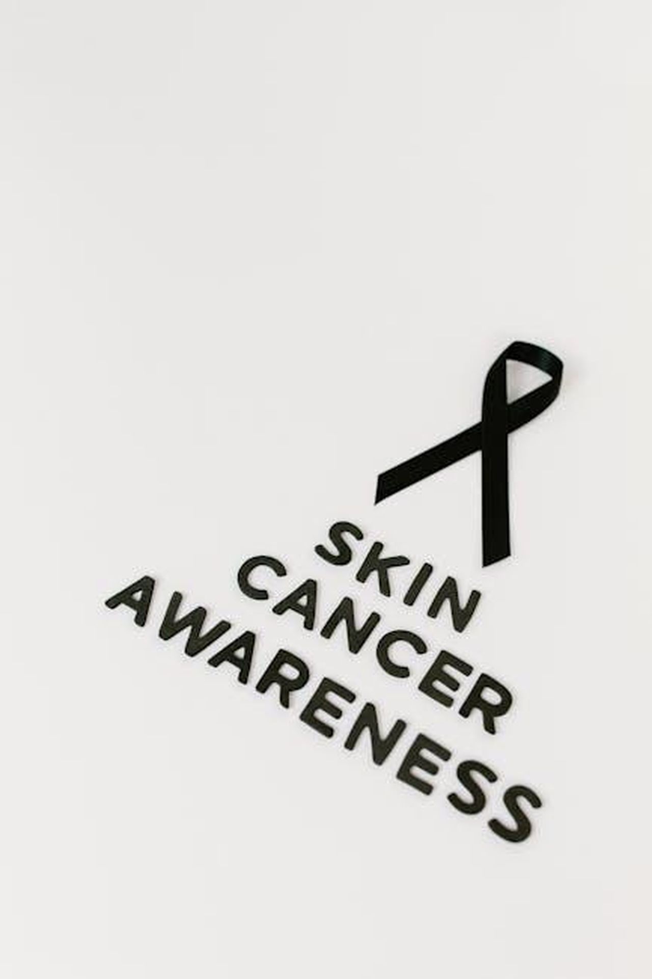 Le_circostanze_della_morte_di_Andrew_Lester_1h9hRaNiFg - Confidenze24 Source: Tara Winstead - pexels - Black ribbon symbolizing skin cancer awareness on a white background.