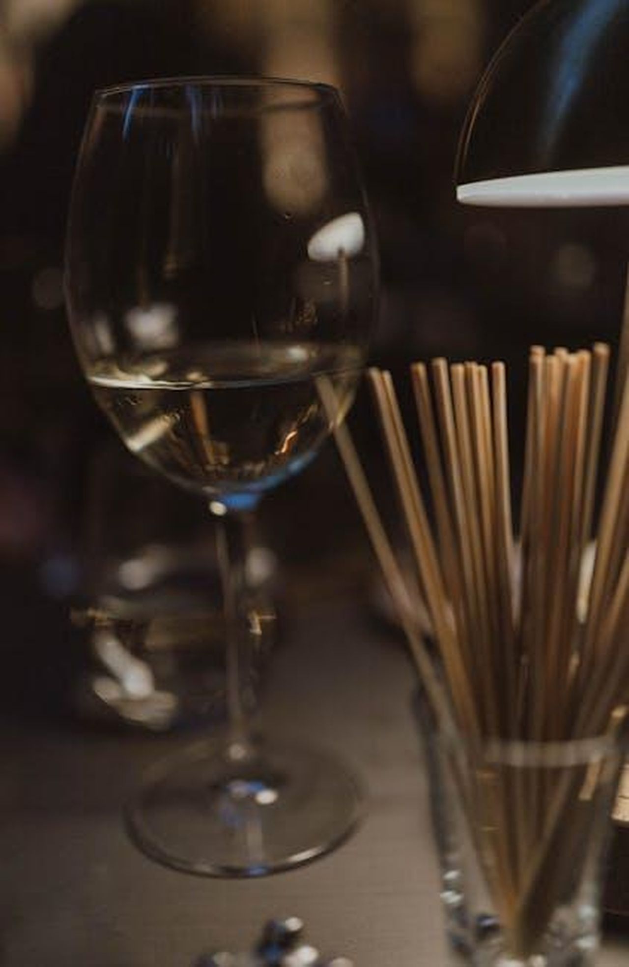 Le_frecciatine_alle_spalle_aQspF7o9iz - Confidenze24 Source: Tuğba Kobal Yılmaz - pexels - Atmospheric scene of a wine glass with dim lighting on a dining table, evoking a cozy vibe.