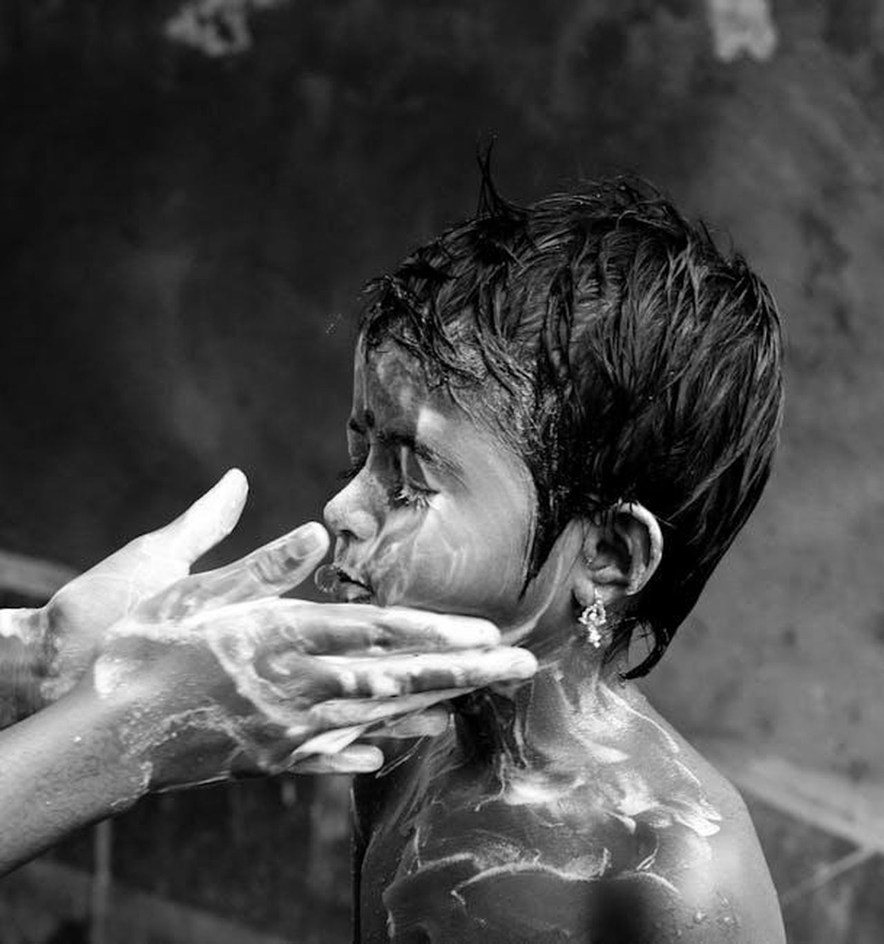 Ozan_scagionato_le_dichiarazioni_dei_testimoni_oj0dLGfDqy - Confidenze24 Source: Utpal Adhikary - pexels - Monochrome image of a child being washed, highlighting gentle hands and soap suds.