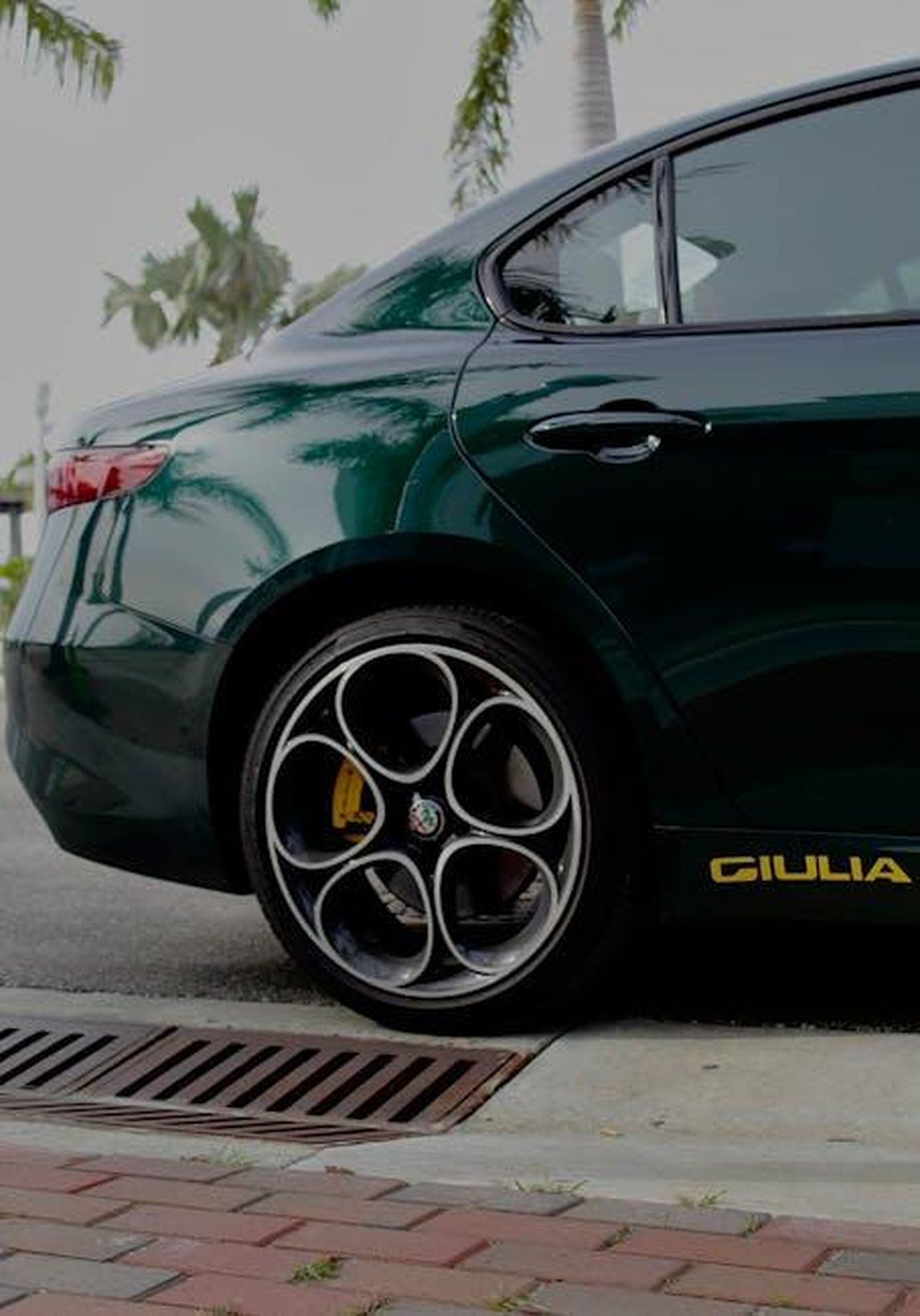 Tancredi_senza_scrupoli_con_Giulia_Furlan_UGcfscsNO6 - Confidenze24 Source: Elijah Labordus - pexels - Rear view of an Alfa Romeo Giulia parked outdoors showcasing its alloy wheels and sleek design.