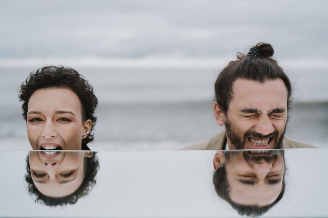 Affleck_si_sente_felice_dopo_il_divorzio_CVNoOPsJ7f - Confidenze24 Source: Anastasia Shuraeva - pexels - A joyful couple shares a laugh at the beach, captured with their reflection.