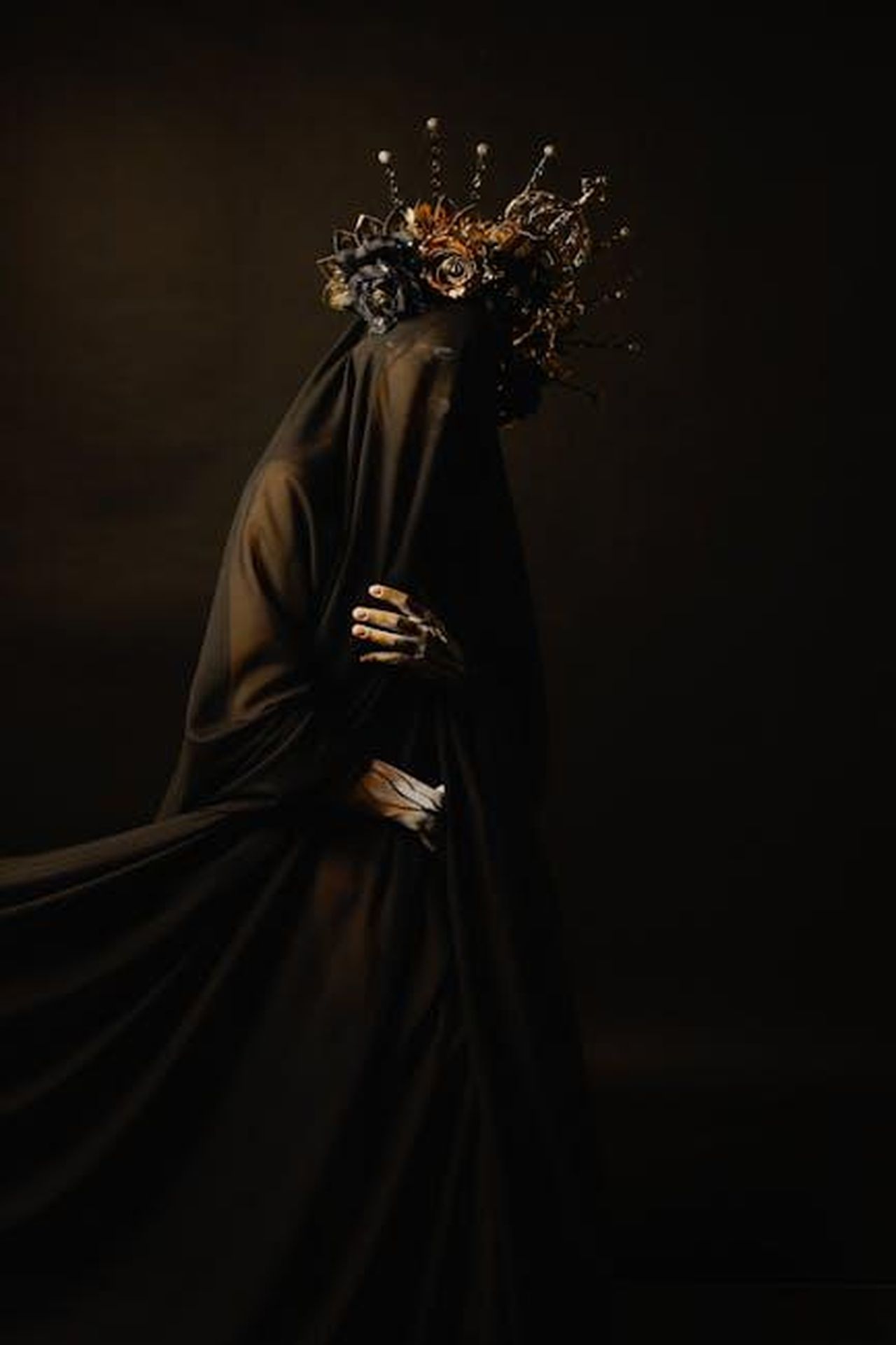 Commenti_sul_look_di_Kate_e_le_sue_scelte_di_gioielli_87oGhIOh25 - Confidenze24 Source: Jonathan Valdes - pexels - Mysterious figure draped in black with an elaborate crown. Eerie and elegant.