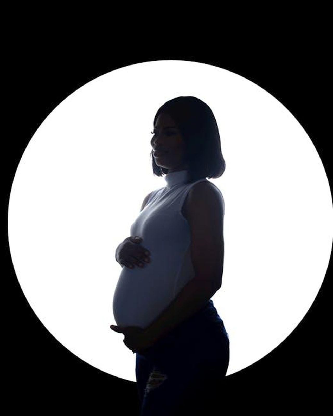Cosa_accadr_quando_William_sar_re_zw1ZNPDn7O - Confidenze24 Source: Heyy Kazz - pexels - Silhouette of a pregnant woman against a white circle background, creating a dramatic effect.