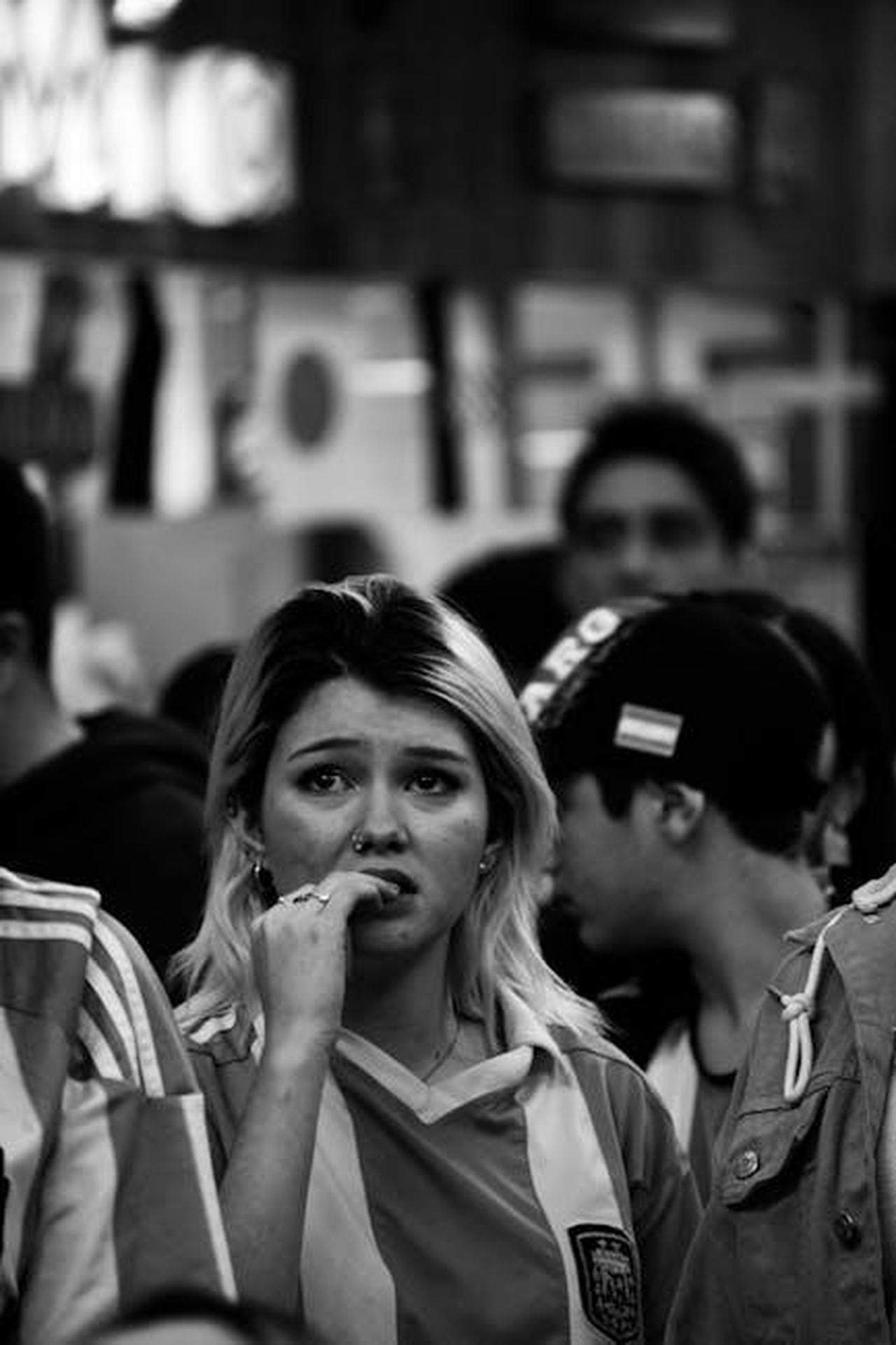 Critiche_dei_telespettatori_su_X_BHH4zuOqV6 - Confidenze24 Source: ἐμμανυελ - pexels - Black and white photo of a nervous woman sports fan in a crowded venue.