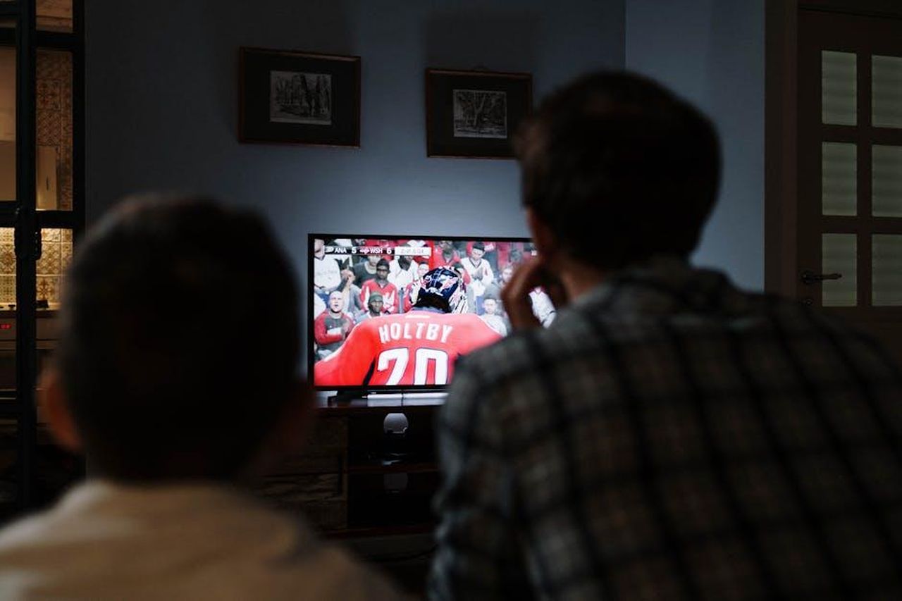 I_fan_non_vedono_lora_che_tornino_insieme_VJNonpSzYR - Confidenze24 Source: cottonbro studio - pexels - Father and son enjoying a hockey game together on TV from their living room.