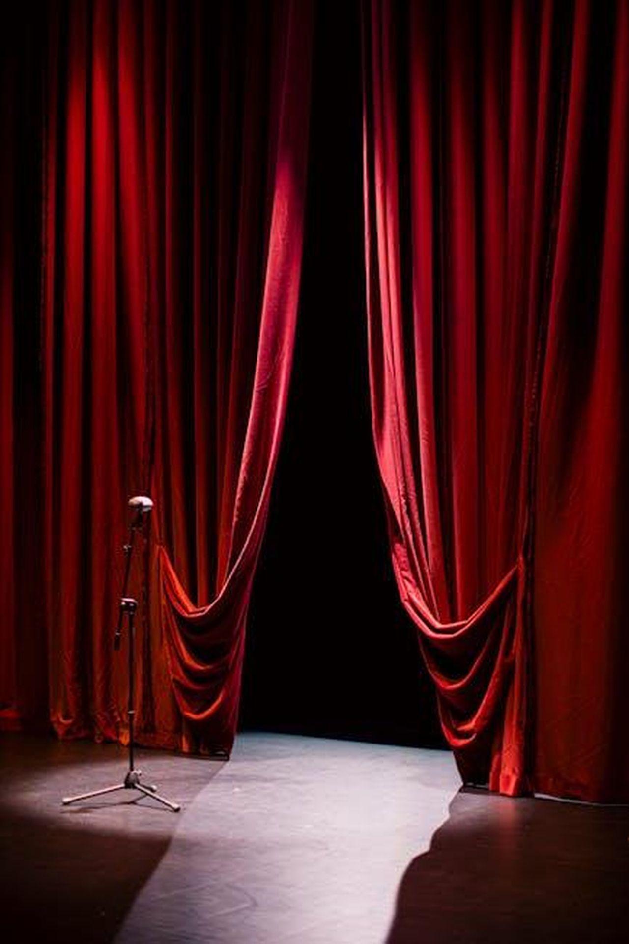 Il_cast_di_Tracker_suggerisce_un_possibile_ritorno_di_Bobby_9Ltma6A3FN - Confidenze24 Source: Martin de Arriba - pexels - A theater stage with closed red curtains and a single microphone in the spotlight, creating a dramatic ambiance.
