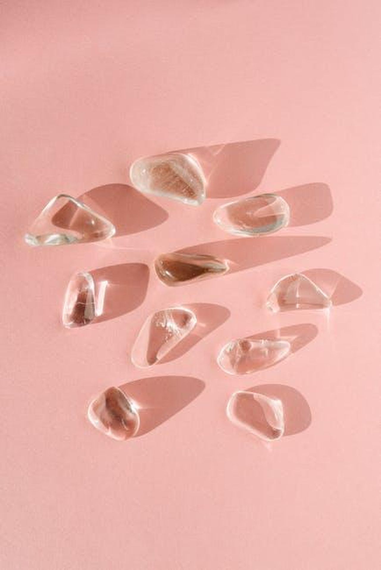 Il_contesto_della_serie_Ghost_Adventures_oSh3o1iN4F - Confidenze24 Source: Mikhail Nilov - pexels - An artistic arrangement of clear quartz crystals casting shadows on a pink surface.