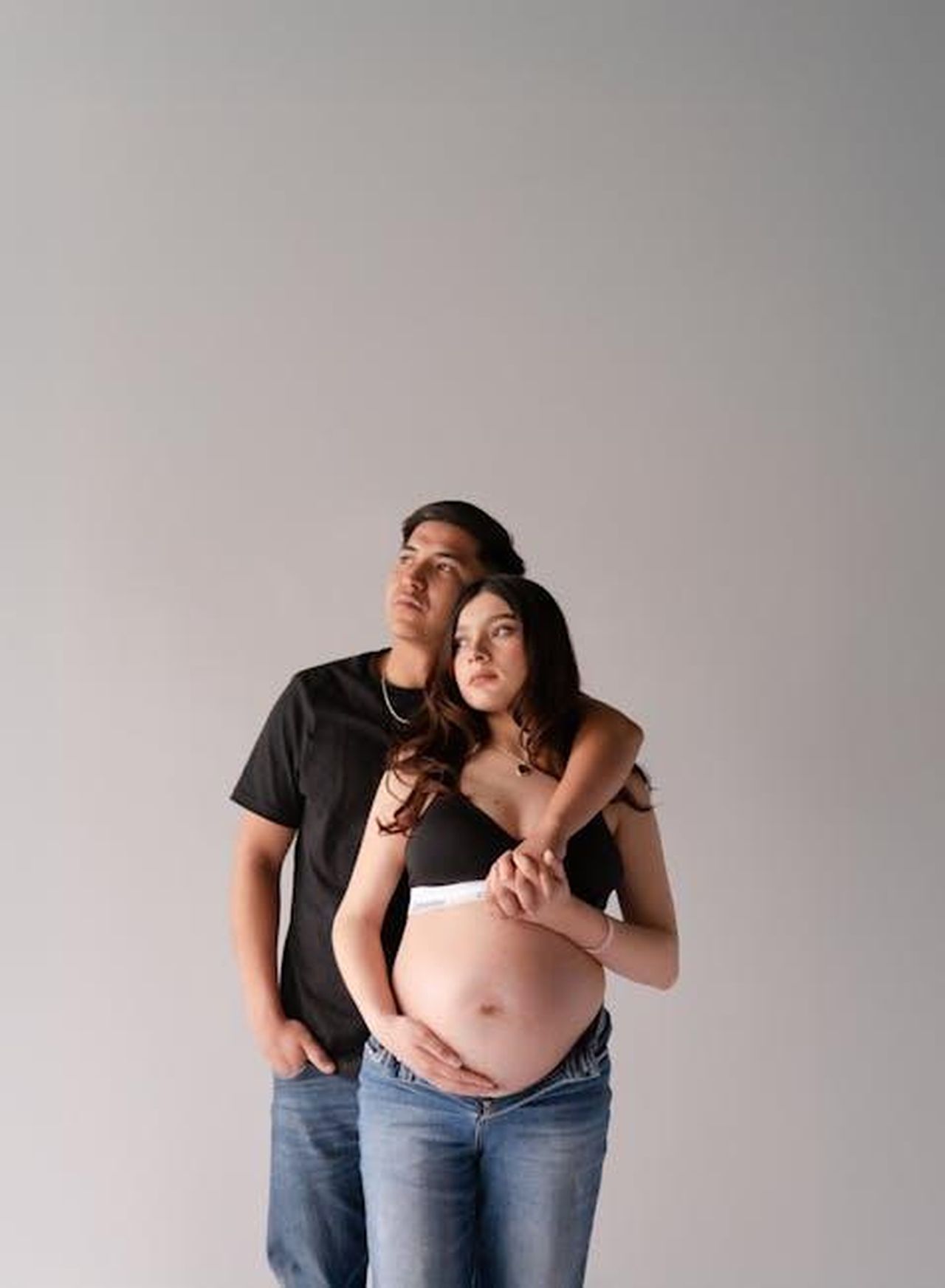 La_lotta_di_Cori_con_la_HELLP_Syndrome_XTkP0NSe9r - Confidenze24 Source: Carlos Santiago - pexels - Expecting couple in casual jeans, embracing in a light studio setting, conveying love and anticipation.
