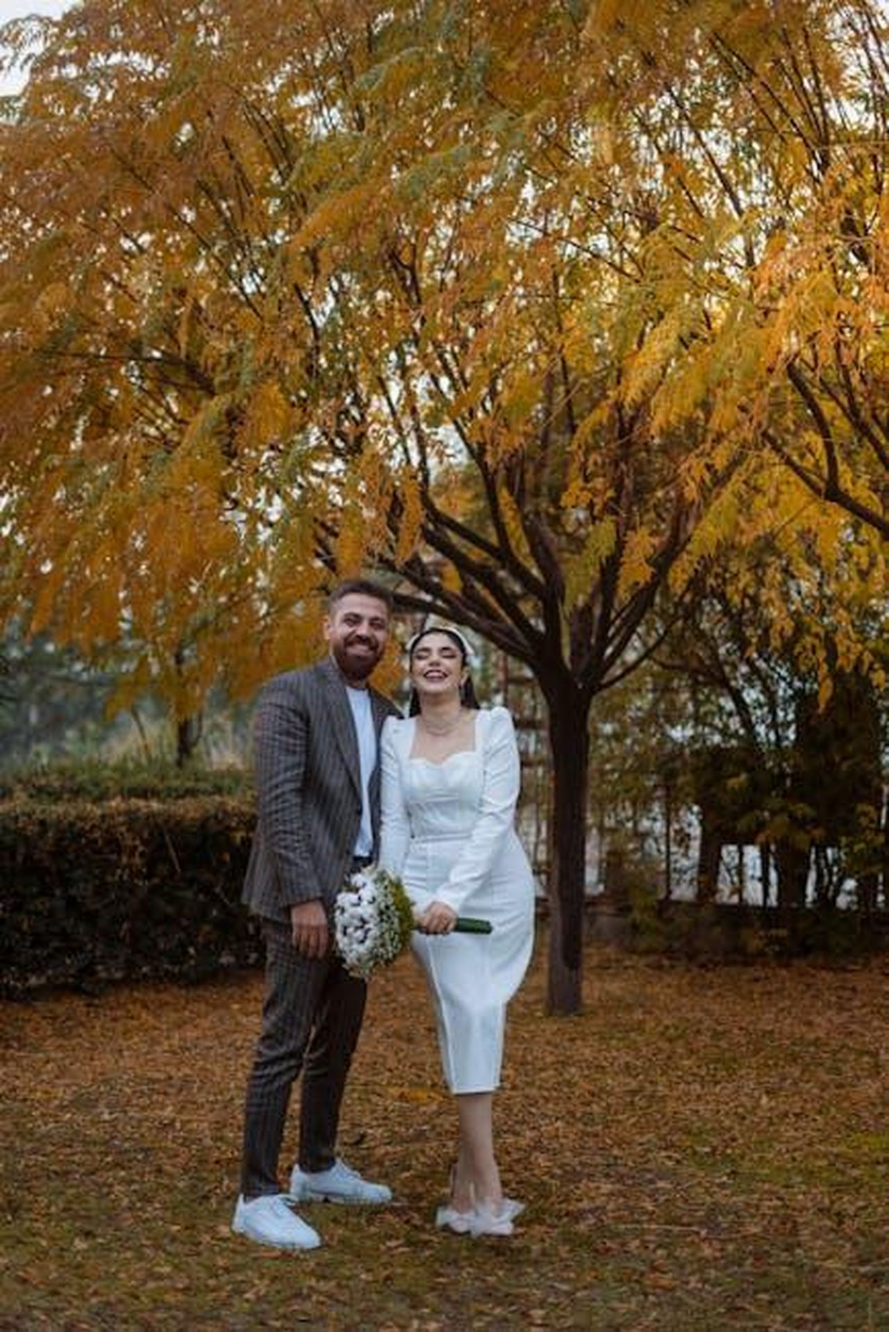 La_storia_damore_tra_Ellen_e_Portia_QwqmTwdWVE - Confidenze24 Source: Daroon jasm - pexels - A happy couple poses under autumn leaves during their outdoor wedding