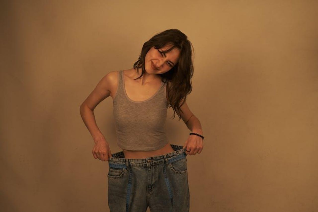 La_trasformazione_di_Nick_Jonas_dopo_la_paternit_hiz8ENOD9I - Confidenze24 Source: Elif - pexels - A woman smiles while holding out the waistband of oversized jeans to show her weight loss success.