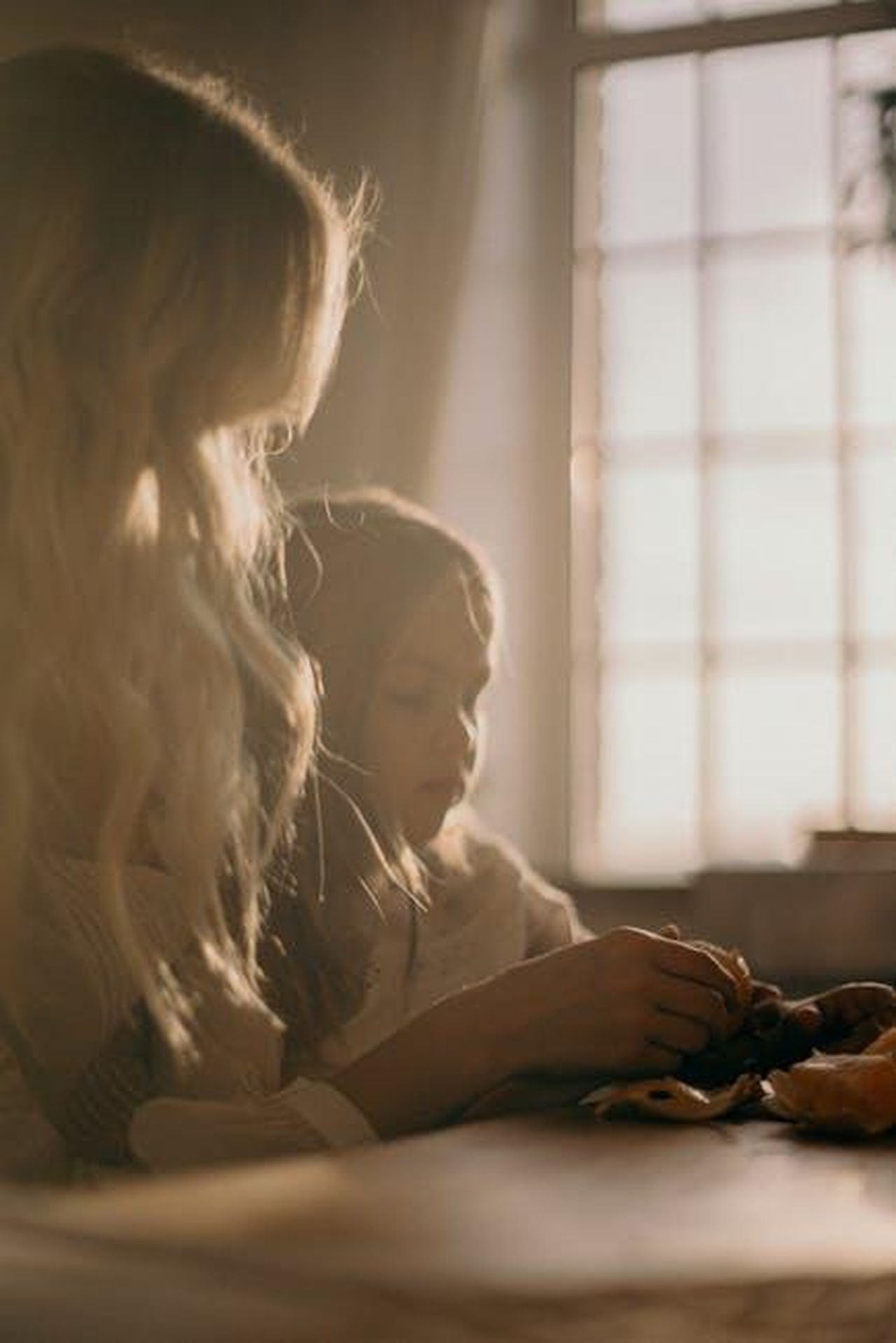 Le_tensioni_tra_i_principi_e_Camilla_HMnhr60tJV - Confidenze24 Source: cottonbro studio - pexels - A warm, intimate moment between a mother and daughter sitting by a sunlit window indoors.