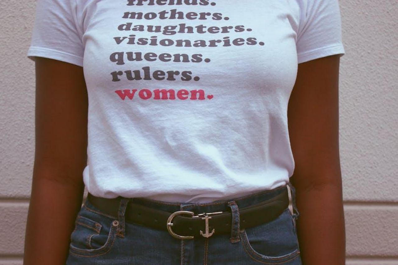 Lizzo_e_il_Suo_Messaggio_di_Empowerment_HB4WGqEWPk - Confidenze24 Source: Chelsi Peter - pexels - Close-up of a t-shirt celebrating women's roles and empowerment.