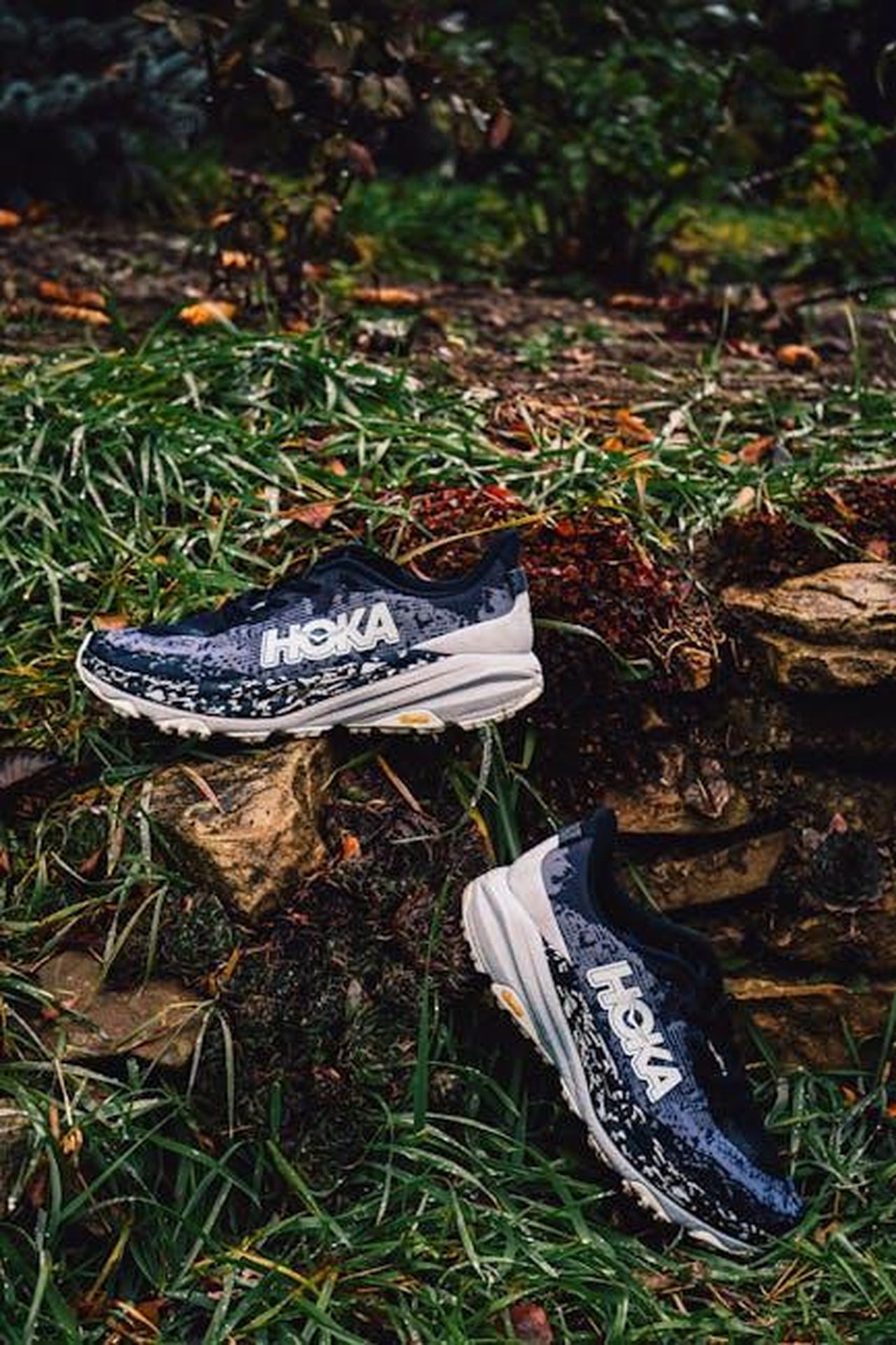 Migliori_offerte_HOKA_per_la_primavera_2025_qZItkeH1p1 - Confidenze24 Source: Alin Serban - pexels - Athletic running shoes on a rocky grassy terrain, perfect for outdoor sports imagery.