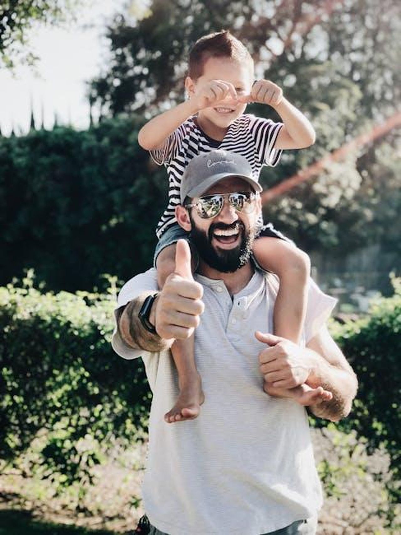 Perch_ha_filmato_a_casa_di_qualcun_altro_eQFJLmatz6 - Confidenze24 Source: Hannah Nelson - pexels - Father giving son a ride on shoulders, both laughing and smiling in a park setting.
