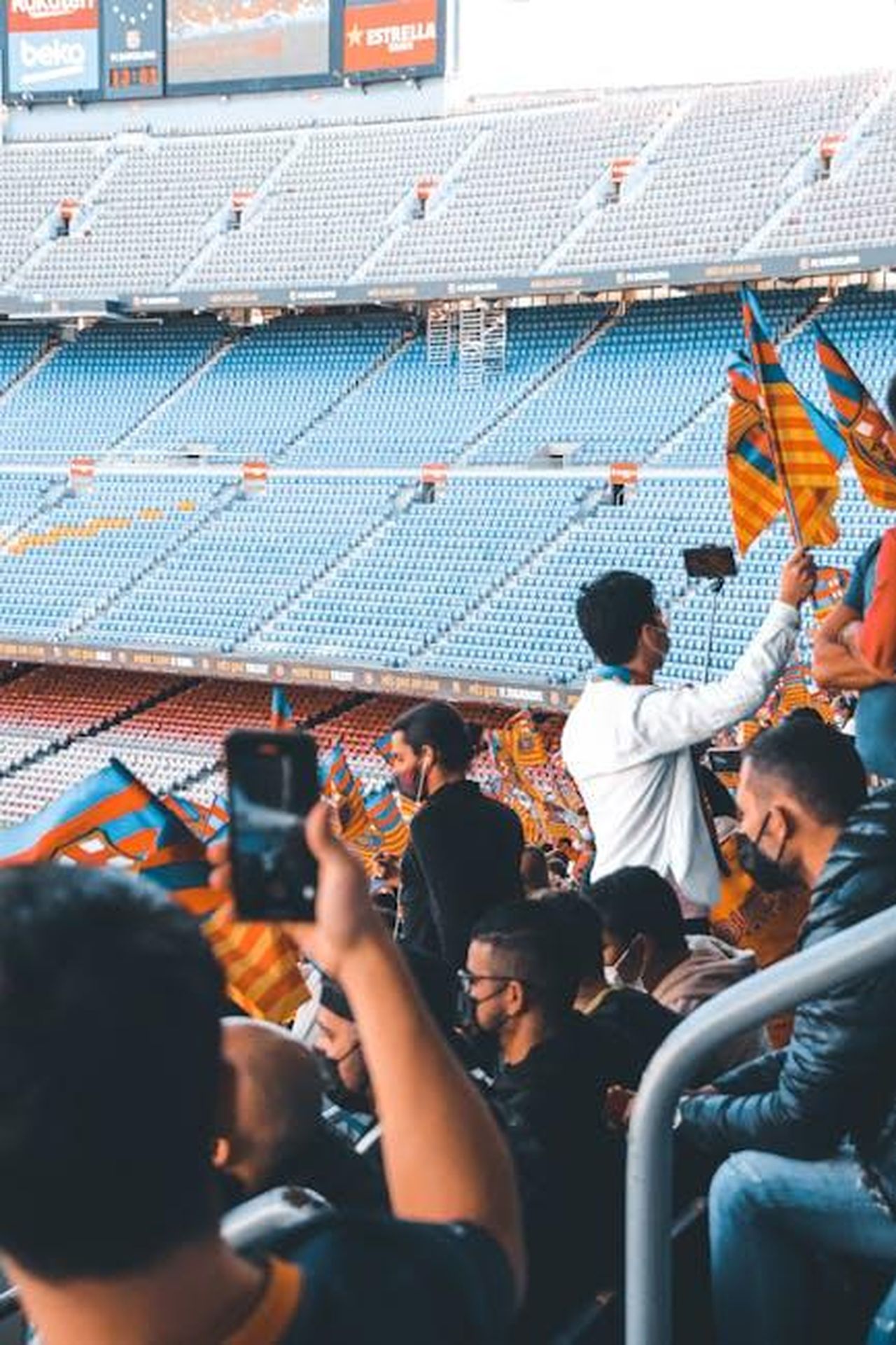 Reazioni_del_pubblico_e_commenti_8U29zYvKYi - Confidenze24 Source: El gringo photo - pexels - Fans with flags enjoying a sports event in a large stadium.