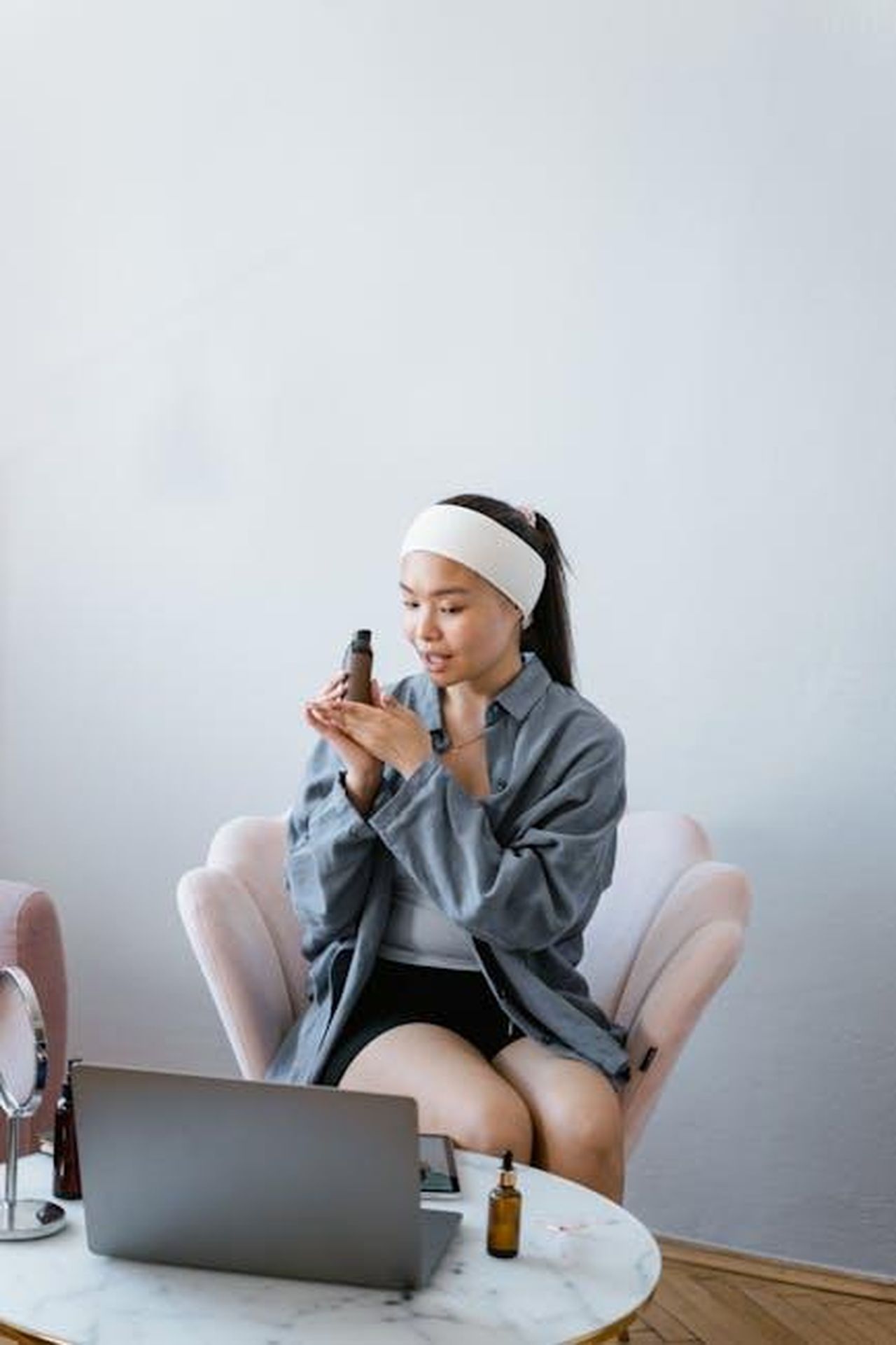 Recensioni_e_opinioni_sul_Rich_Cream_CoEmOro100 - Confidenze24 Source: MART PRODUCTION - pexels - Young woman with headband reviews beauty products at home using laptop.