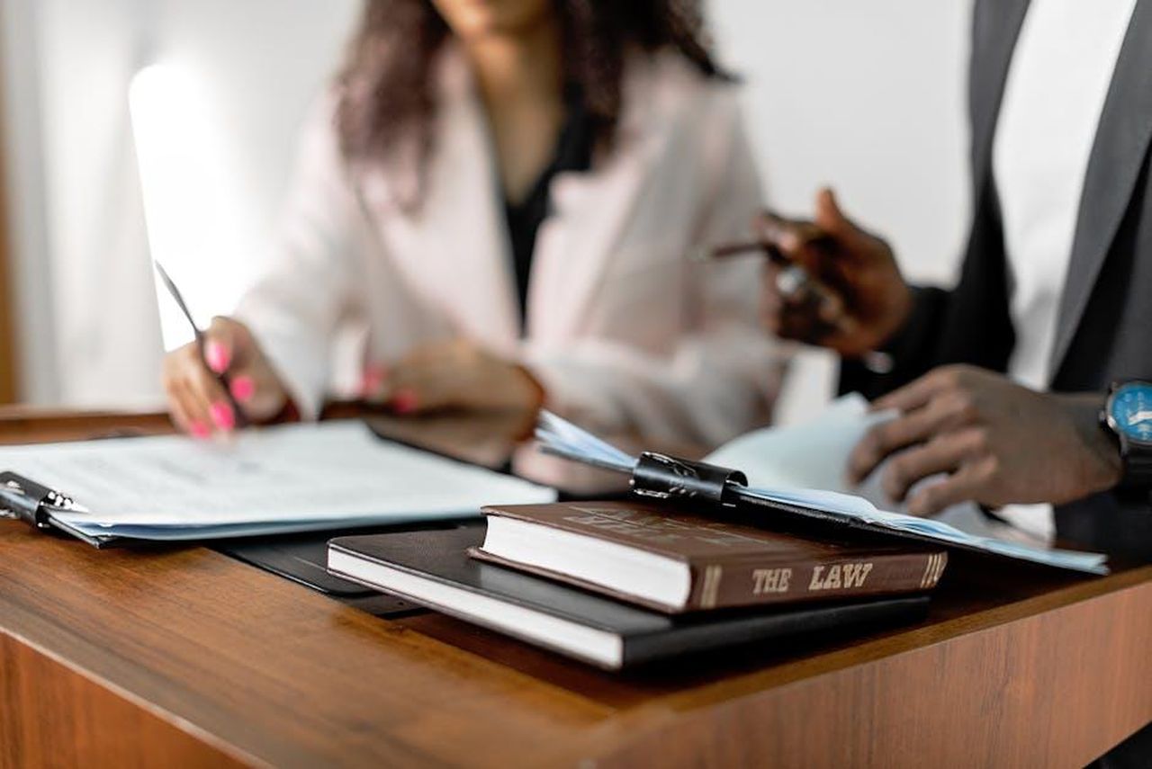Recensioni_entusiastiche_dei_lettori_Wsj5mTgTSi - Confidenze24 Source: Mikhail Nilov - pexels - Two lawyers reviewing documents with law books on a desk. Professional legal environment.