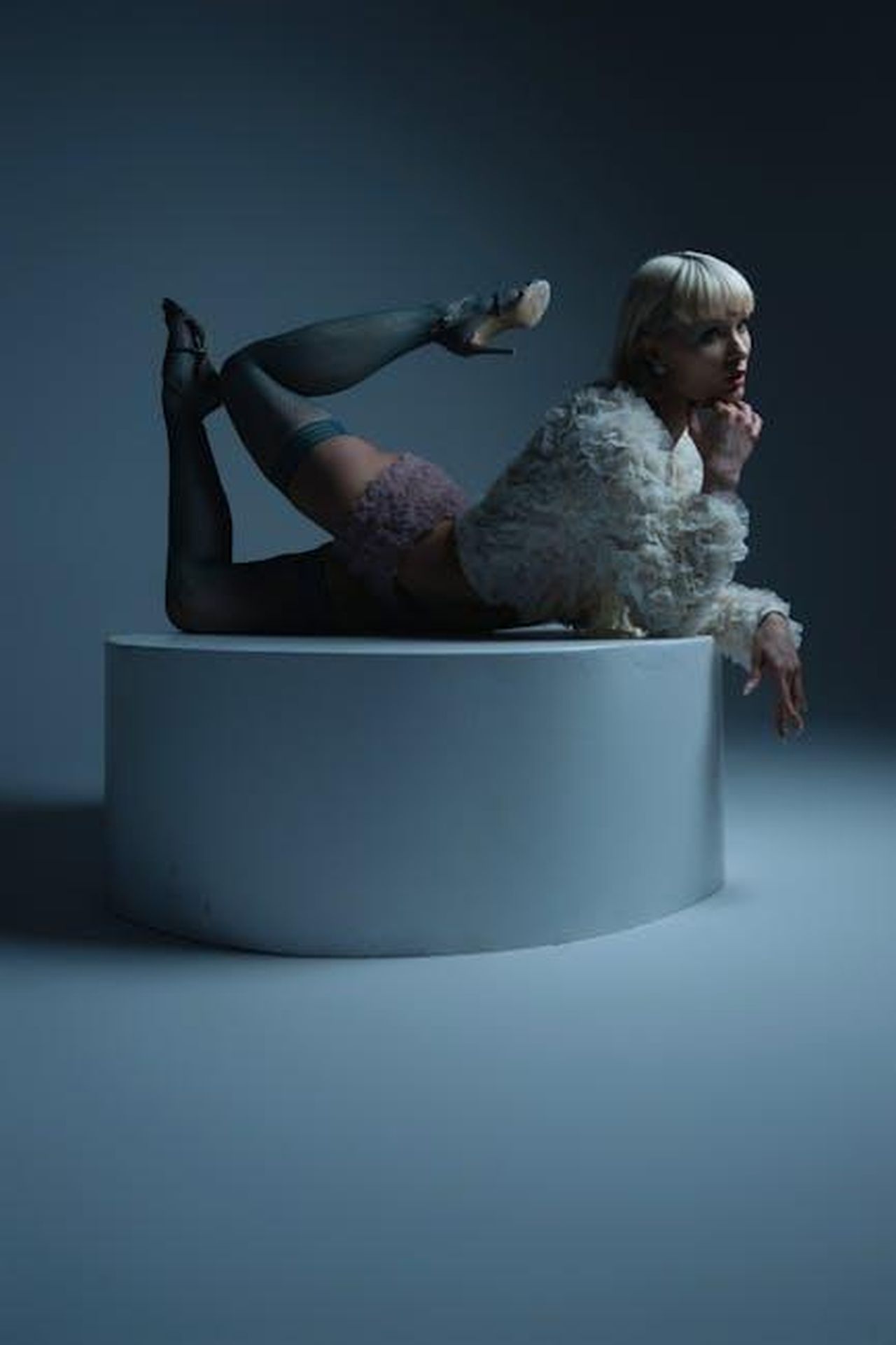 Sunday_Rose_figlia_di_Nicole_Kidman_sulla_passerella_Miu_Miu_wTMA74l3TI - Confidenze24 Source: Jay Soundo - pexels - Stylish model posing on a pedestal in a moody studio setting, showcasing high fashion