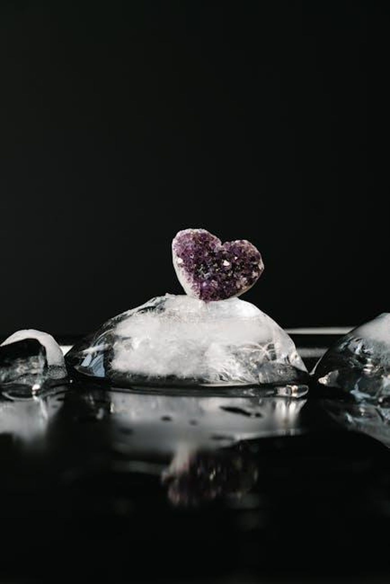 Torvill__Dean_sul_futuro_di_Dancing_on_Ice_QhgWGpuWon - Confidenze24 Source: Mikhail Nilov - pexels - A heart-shaped amethyst crystal atop melting ice against a dark background.
