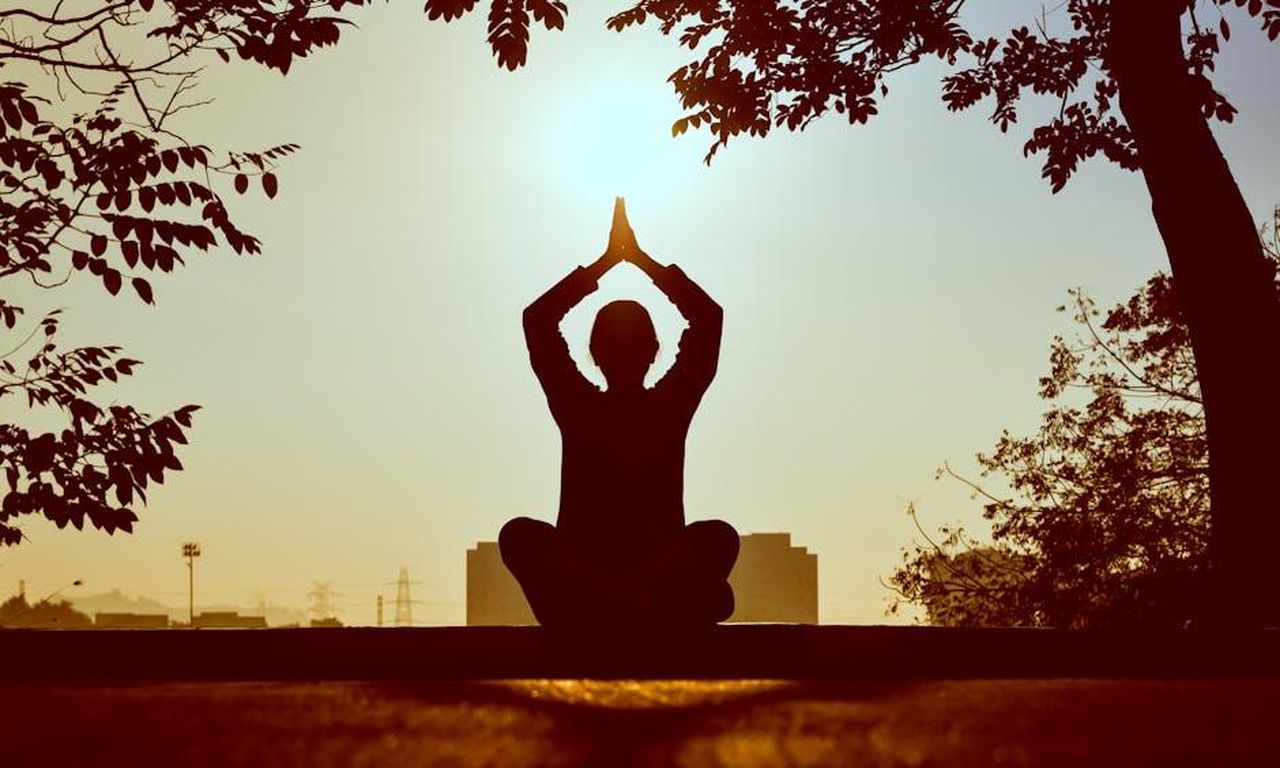 Yoga_e_momenti_di_affetto_522cwSO1zv - Confidenze24 Source: Prasanth Inturi - pexels - Silhouette of a person practicing yoga outdoors during sunrise, creating a calming atmosphere.