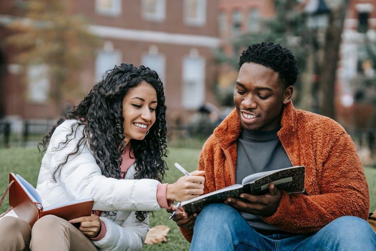 Zahara_e_la_sua_esperienza_alluniversit_rFG8KoGwOs - Confidenze24 Source: Keira Burton - pexels - Happy college students studying together on a campus lawn, sharing ideas and writing notes.